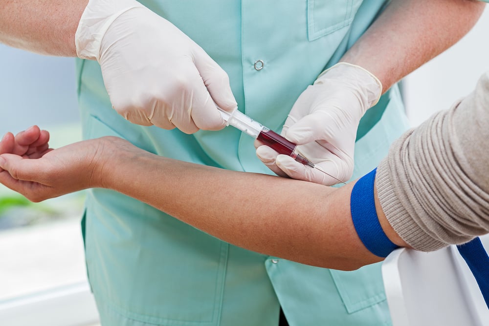 Phlebotomist collecting a blood sample from a patient Phlebotomist collecting a blood sample from a patient